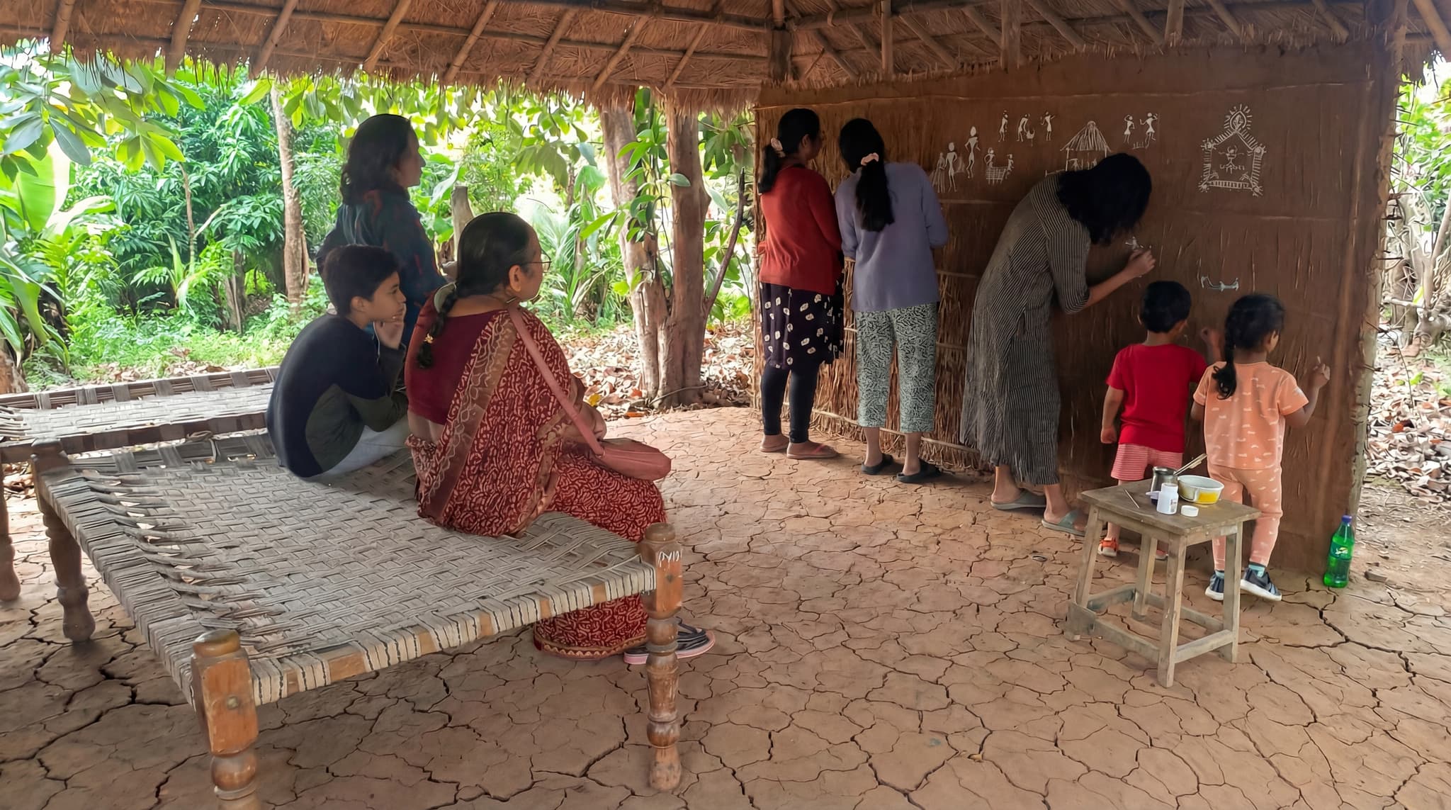 Visitors learning Warli painting and pottery with local tribal artisans at Save Farm workshop